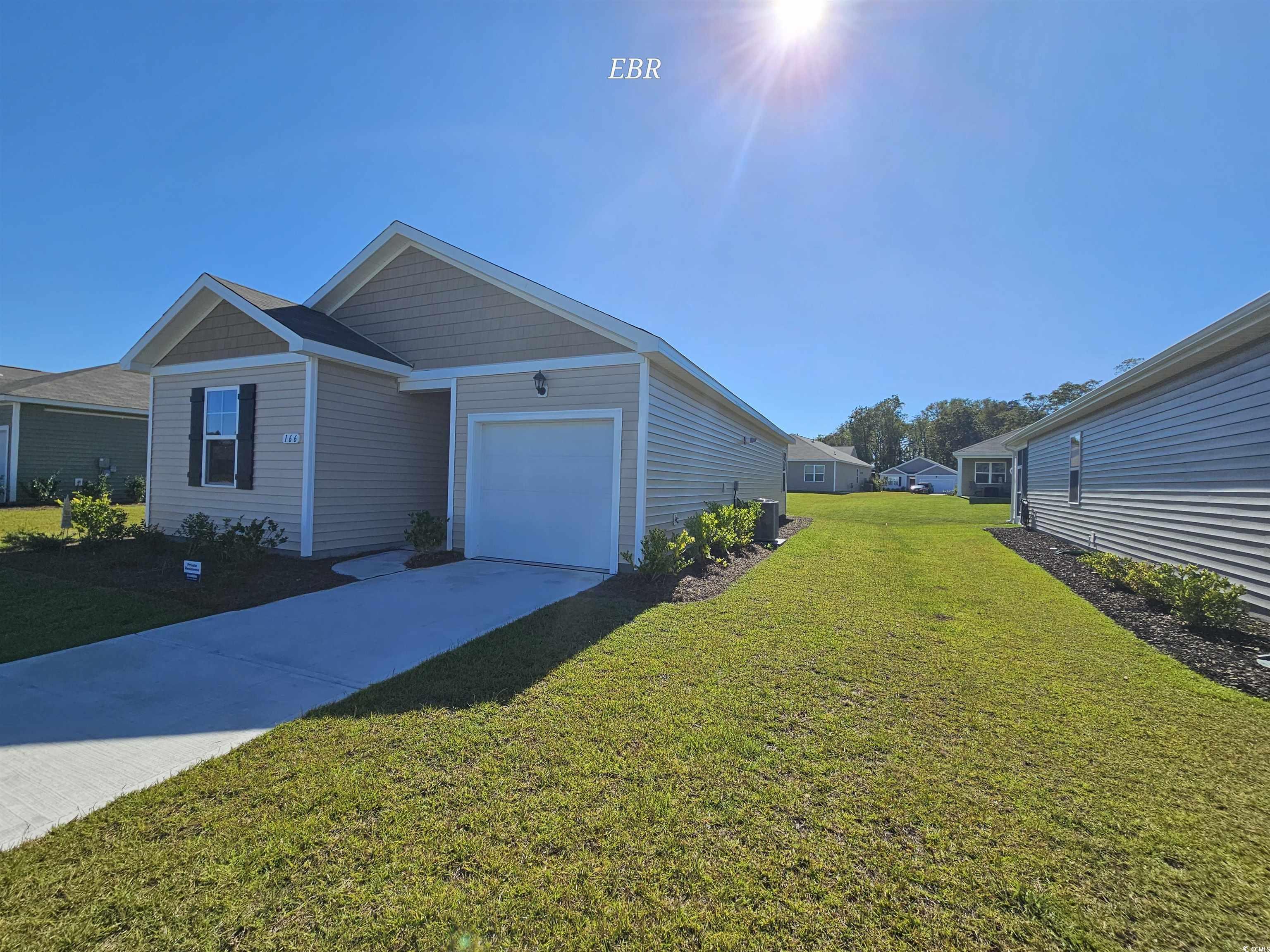 View of front of home featuring a front lawn, cent