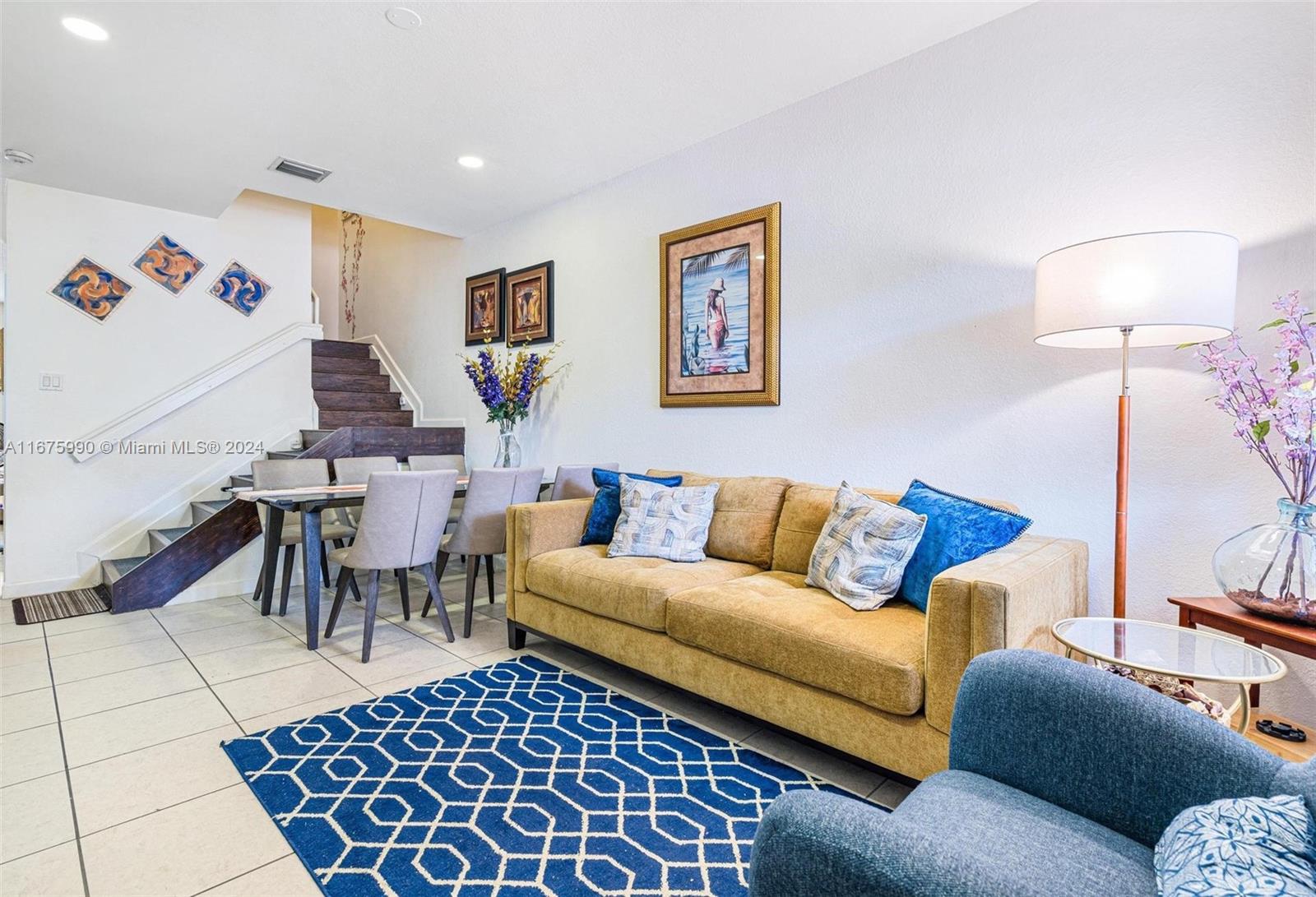 a living room with furniture and a lamp