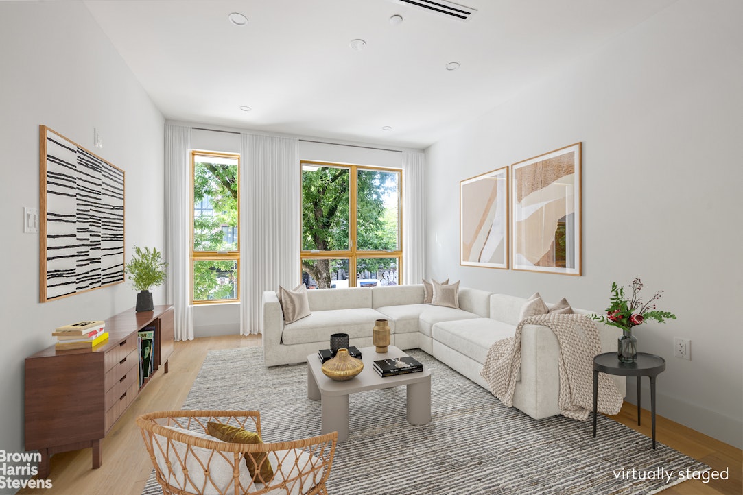 a living room with furniture and floor to ceiling windows