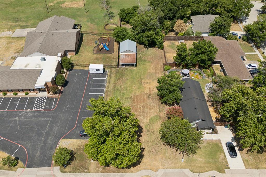 an aerial view of a house with a yard