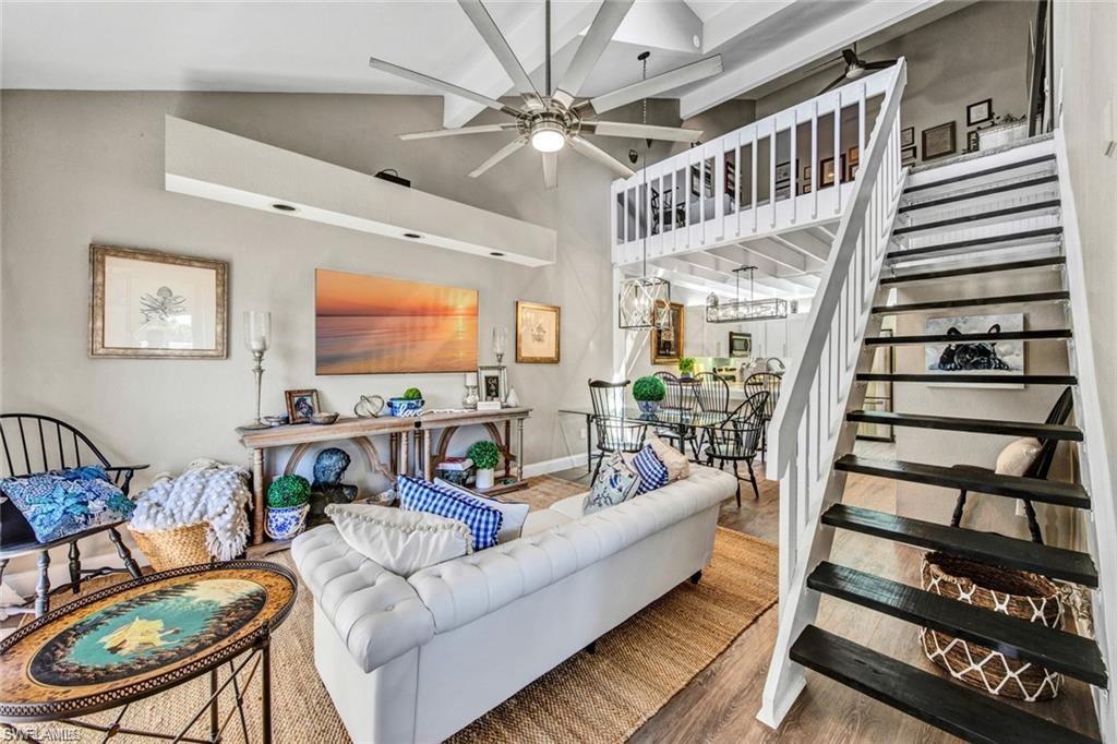 a living room with furniture ceiling fan and a rug