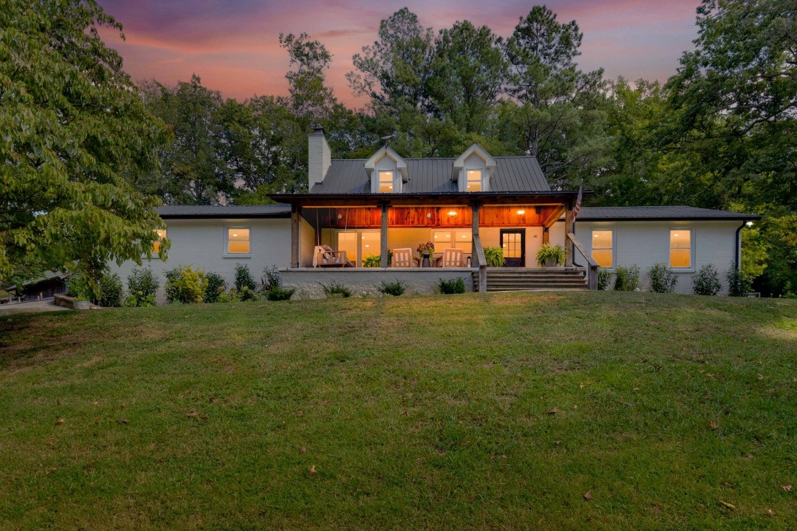 a front view of a house with a garden and yard