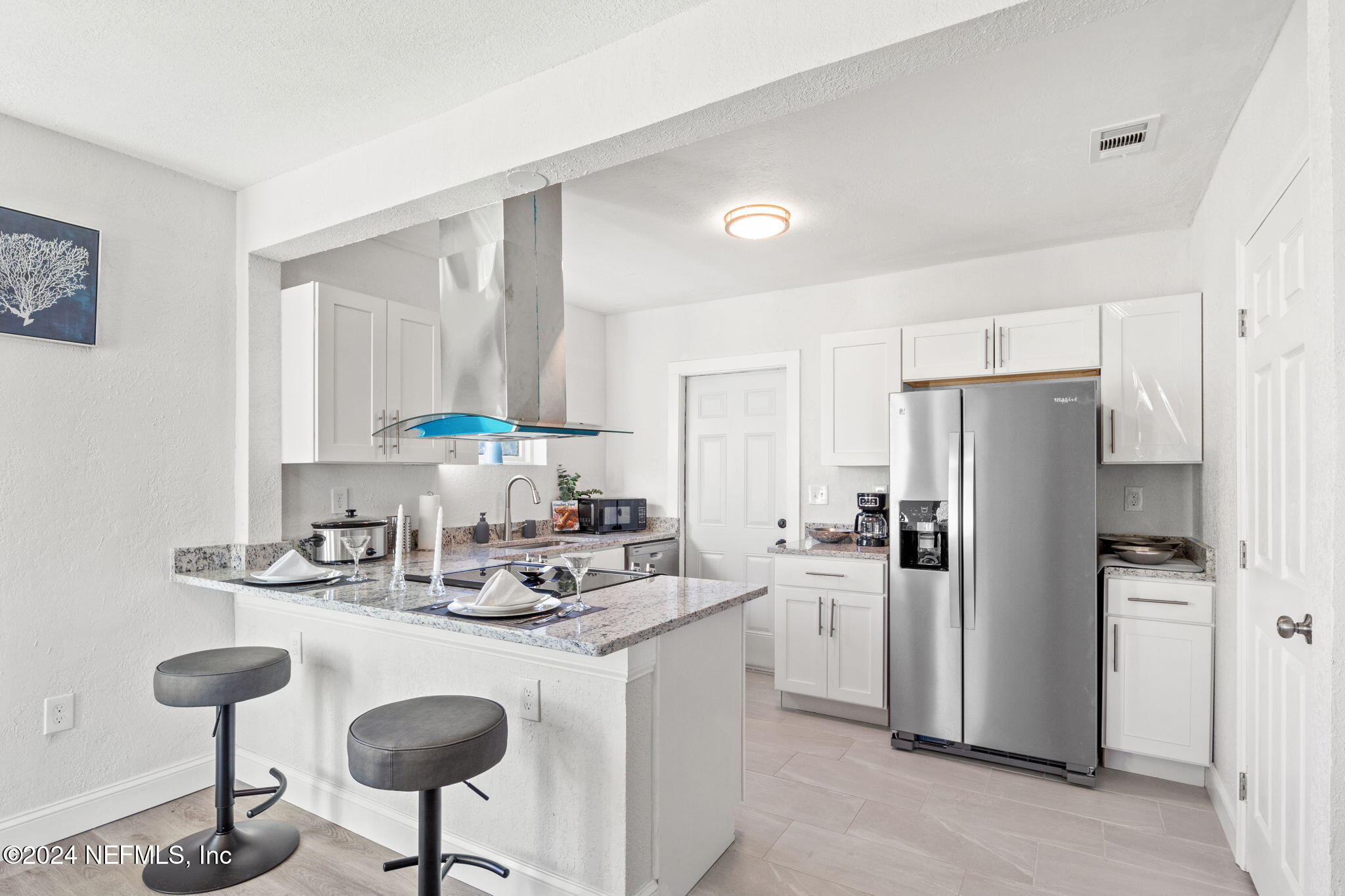 a kitchen with refrigerator and cabinets