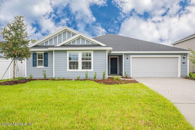 a front view of a house with yard and garage