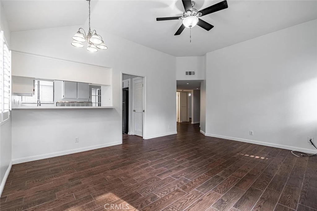 a view of a kitchen with wooden floor and a ceiling fan