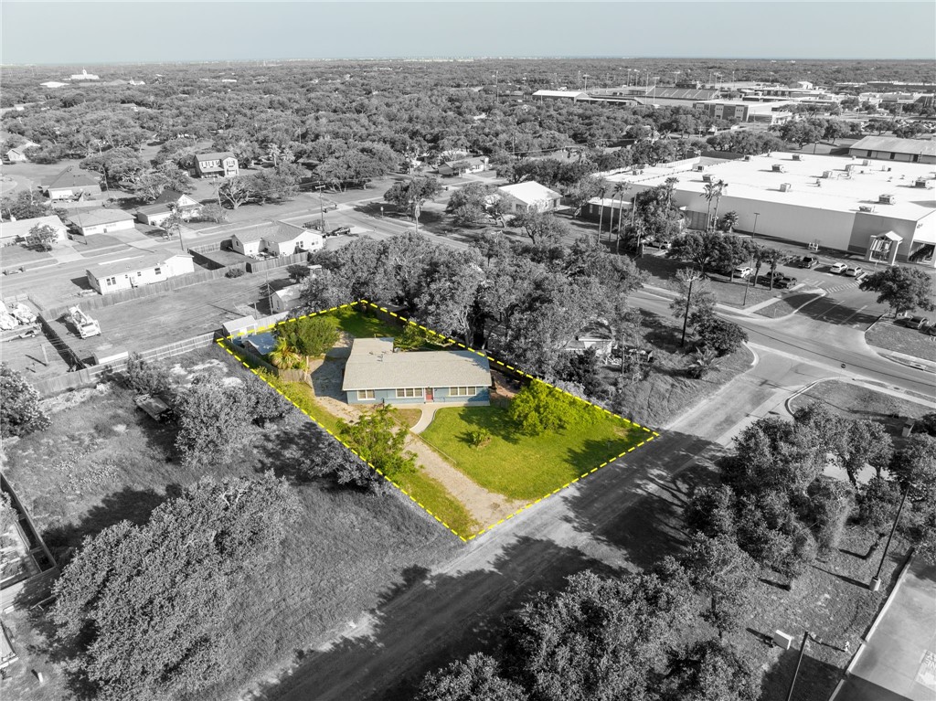 an aerial view of a house with a yard and lake view