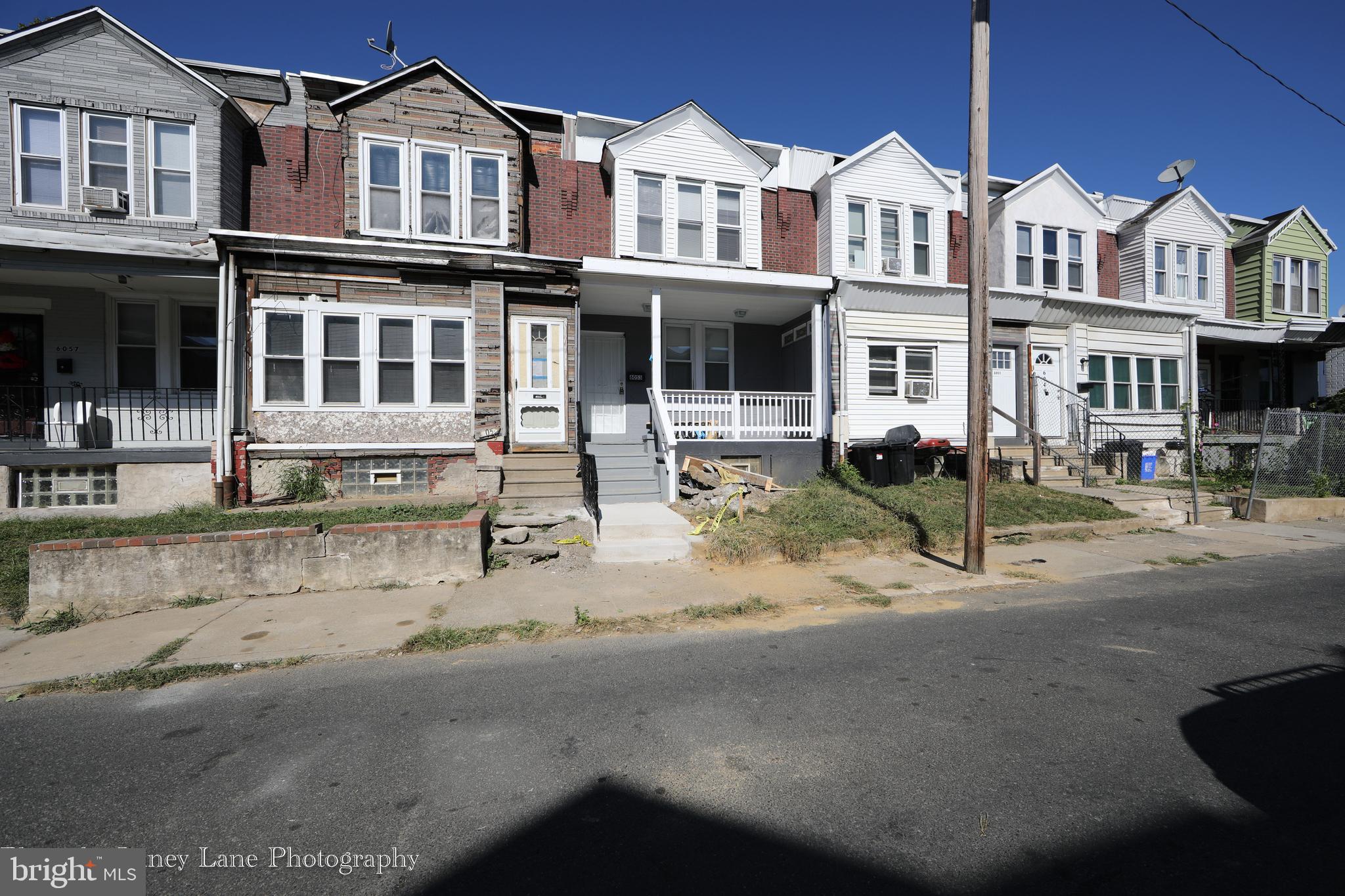 a front view of a residential apartment building with a yard