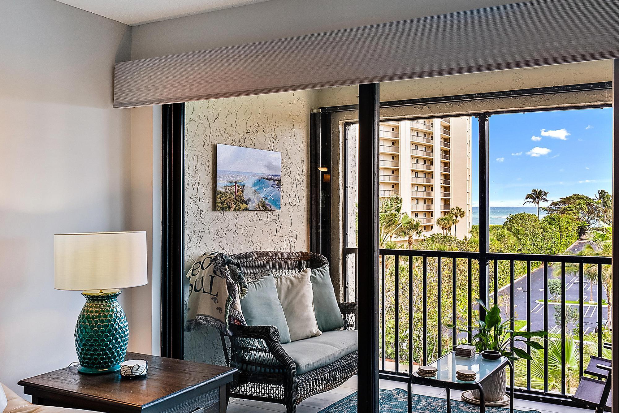 a balcony with furniture and a potted plant