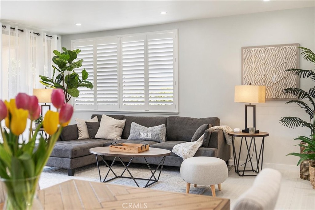 a living room with furniture and a lamp