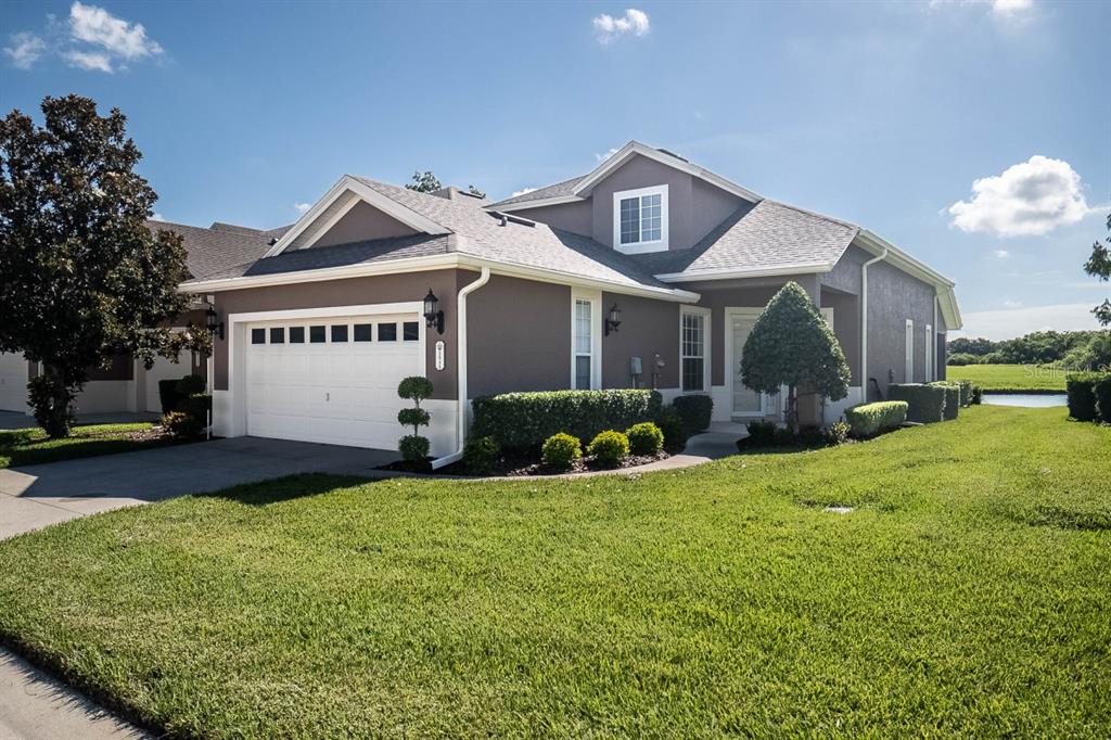 a front view of a house with a yard and garage