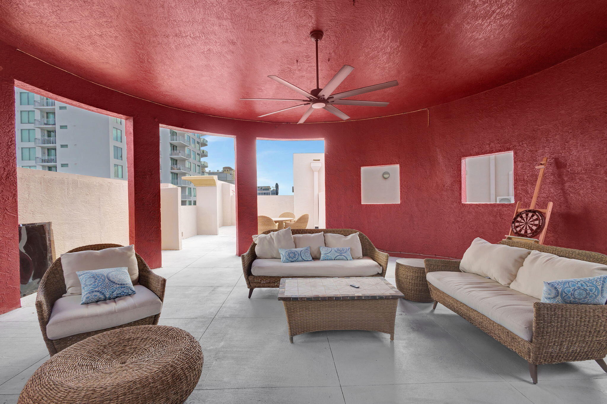 a living room with furniture a ceiling fan and a rug