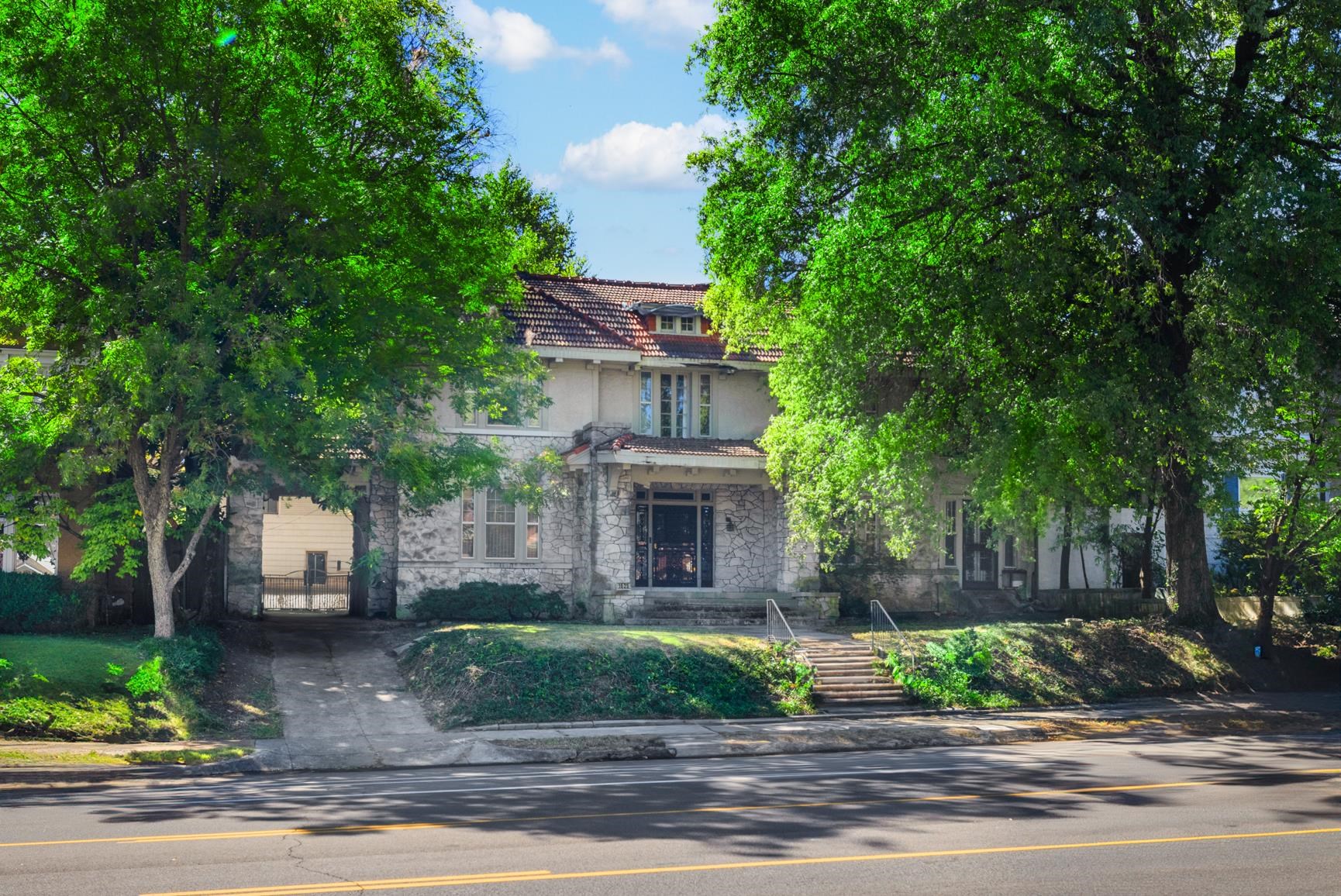 a front view of a house with a garden