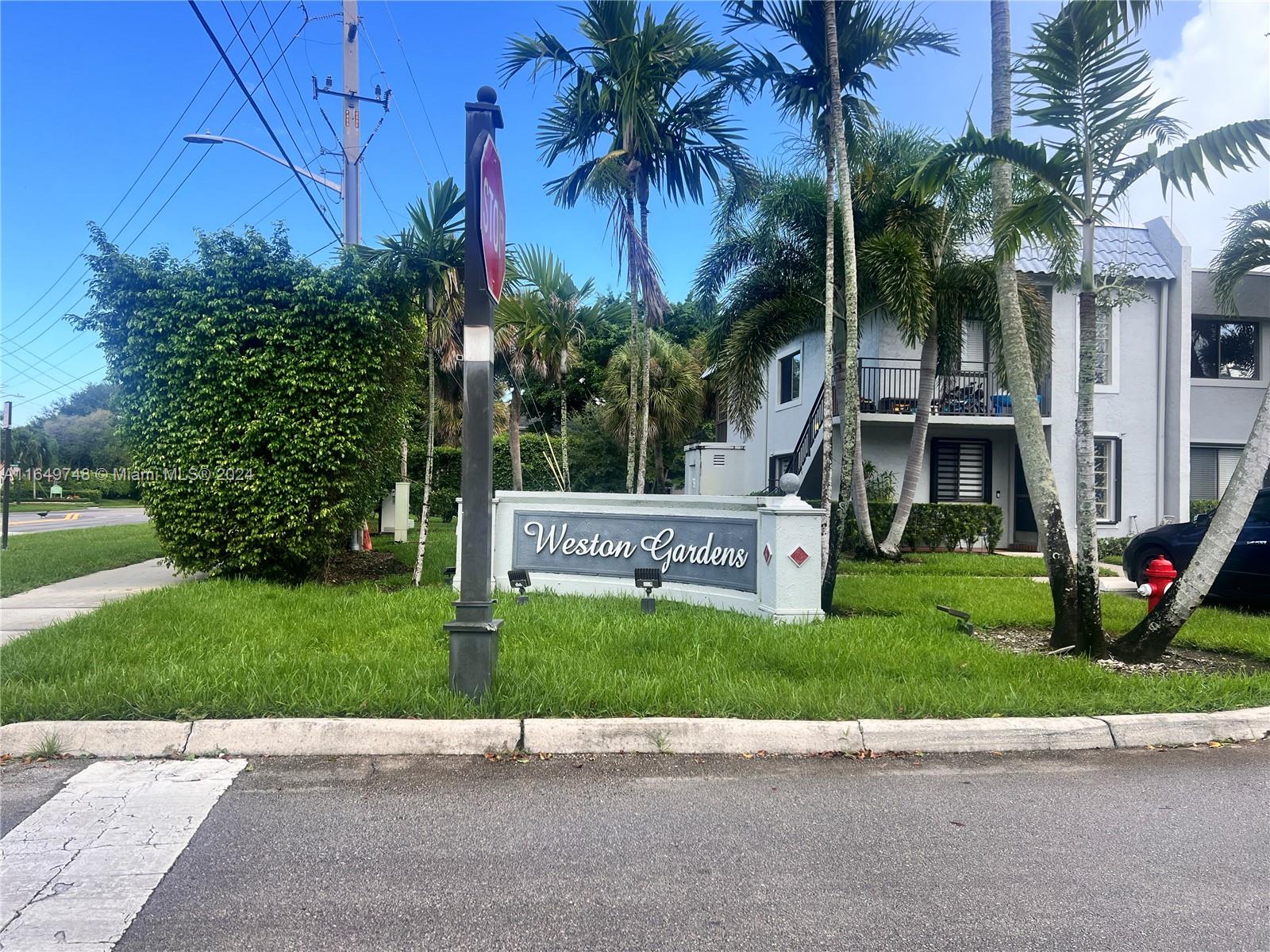 a view of garden with a sign board