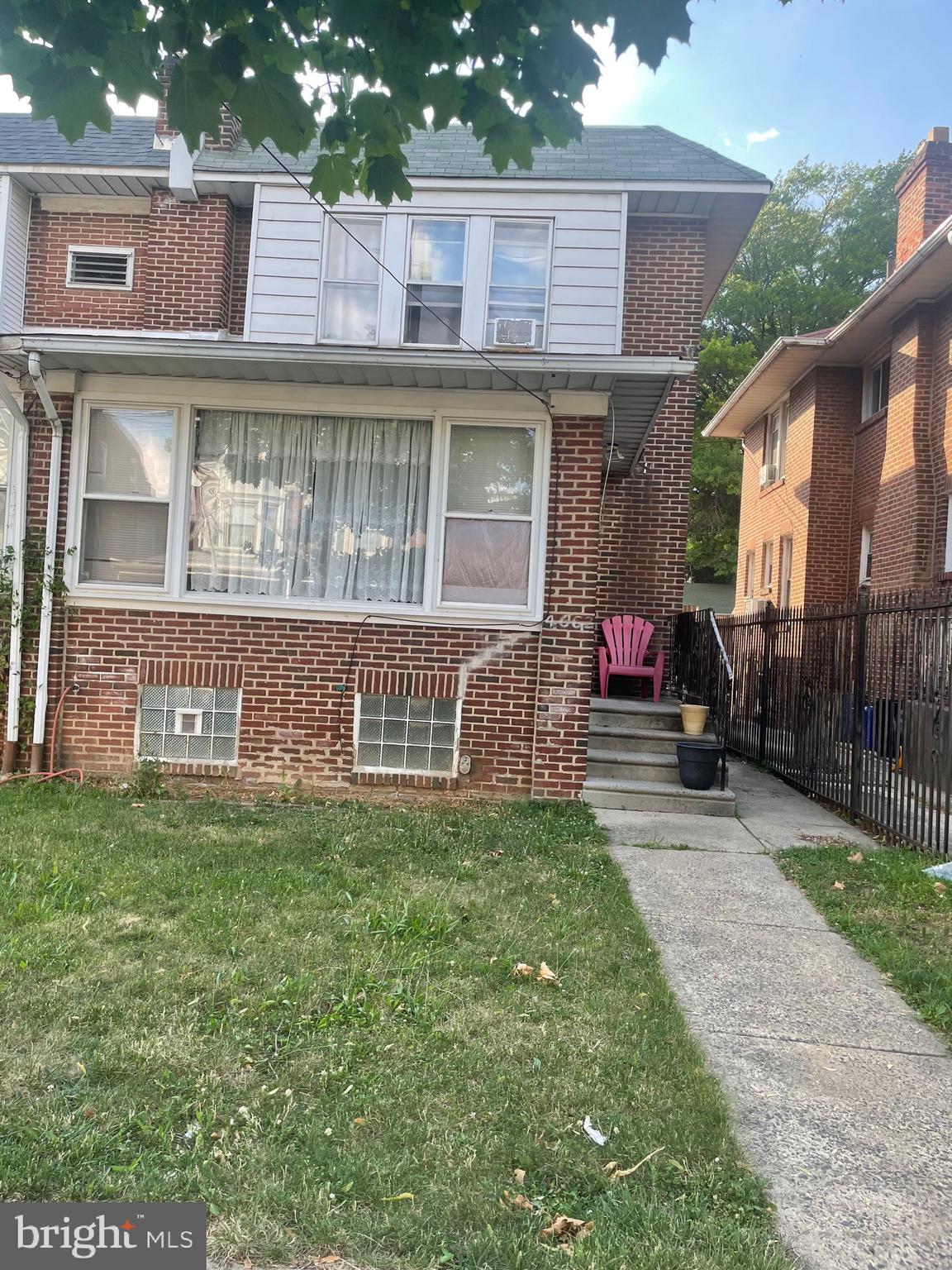 a view of a house with a yard and sitting area