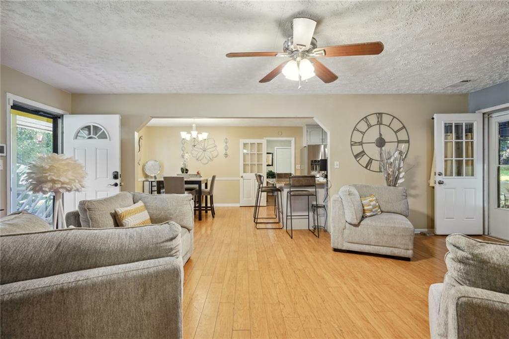 a living room with furniture and wooden floor