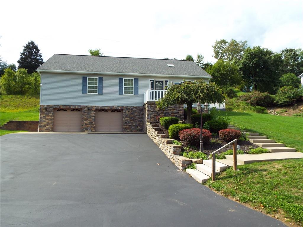 a front view of house with yard and outdoor seating