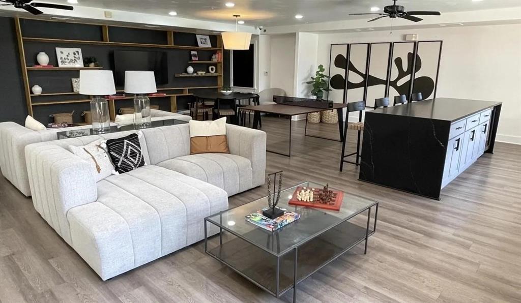 a living room with furniture a rug and a wall painting