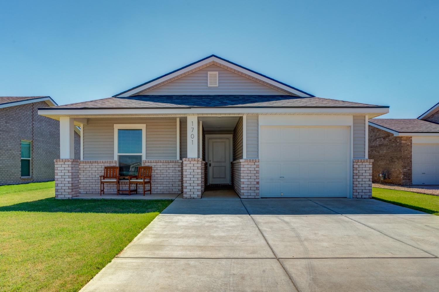 a front view of house with yard and outdoor seating