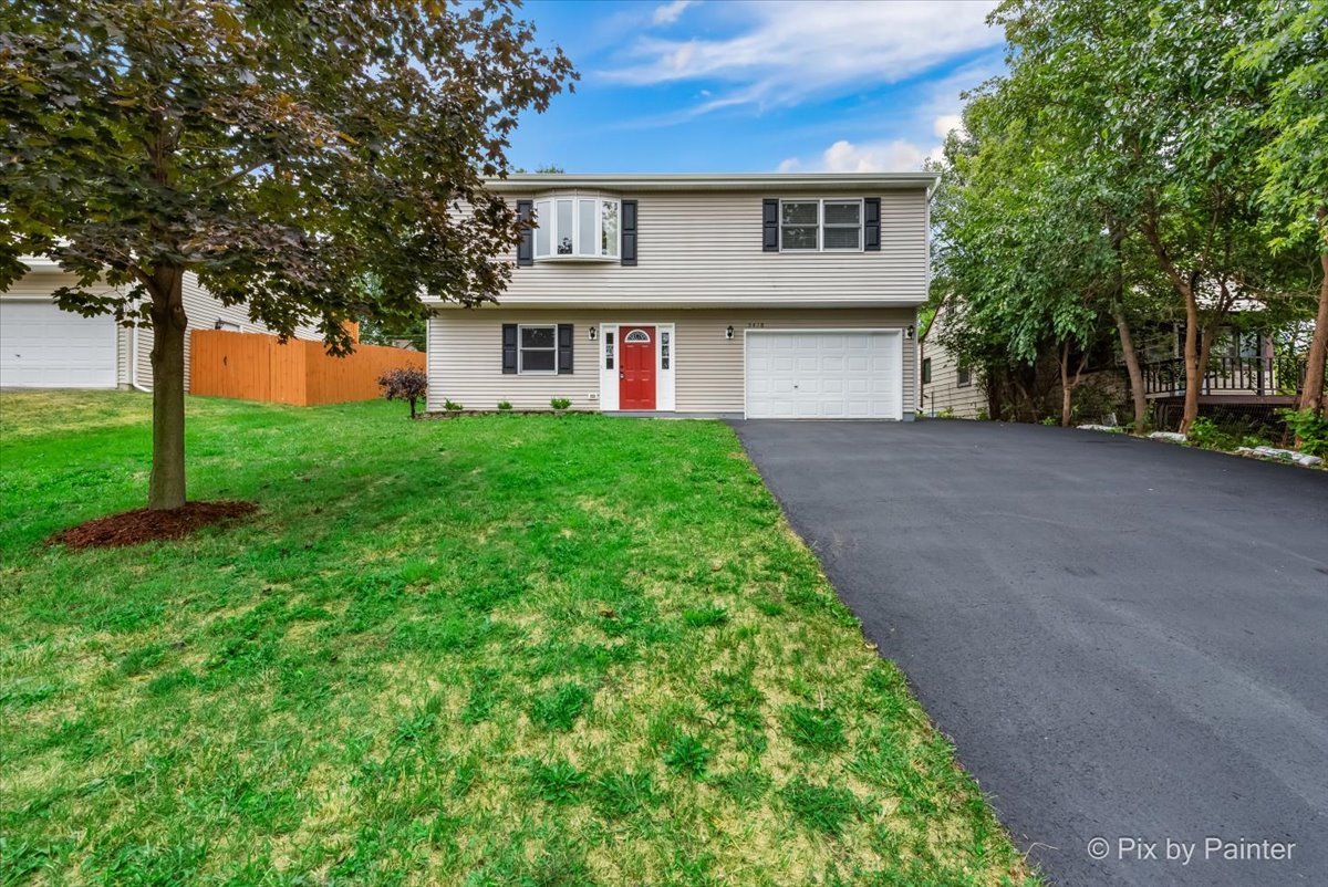 a front view of a house with a yard and garage