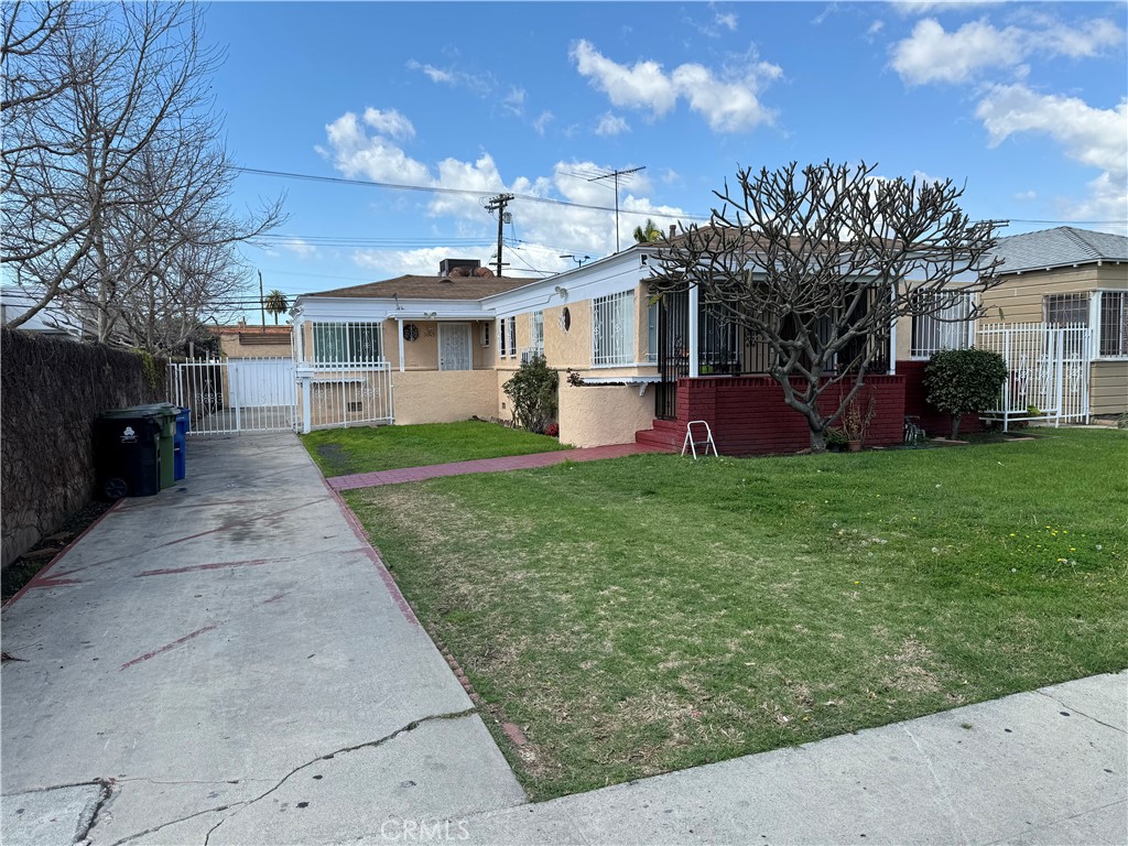 a view of a house with a yard and tree s