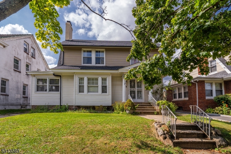 a view of a house with backyard porch and sitting area