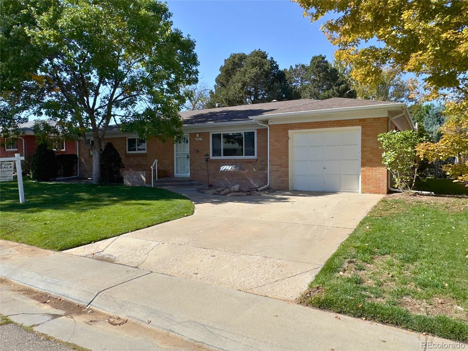 a front view of house with yard and trees