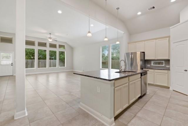 a kitchen with stainless steel appliances granite countertop a stove and a sink