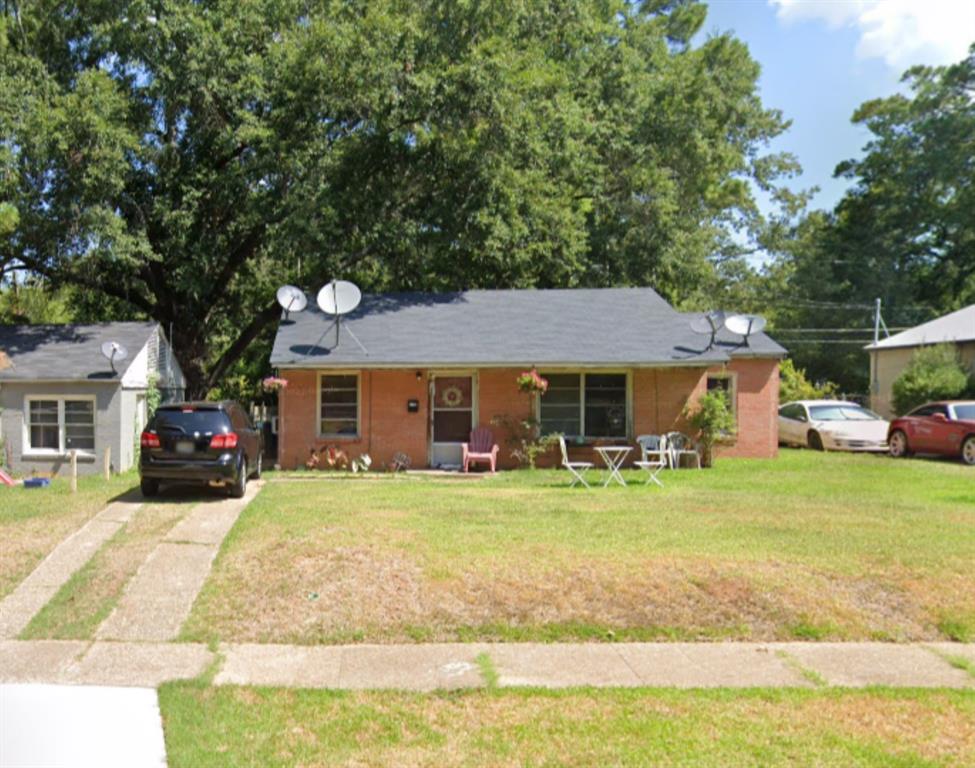 a front view of a house with a porch and a yard