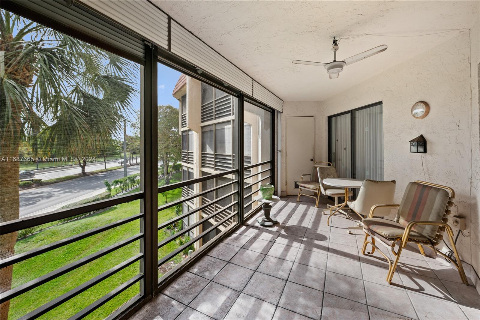 a view of a porch with furniture and a yard