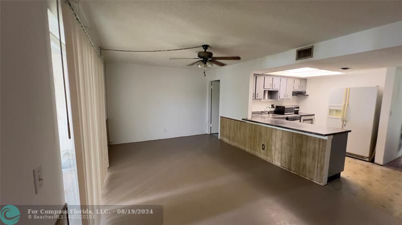 a kitchen with kitchen island a sink stainless steel appliances and cabinets