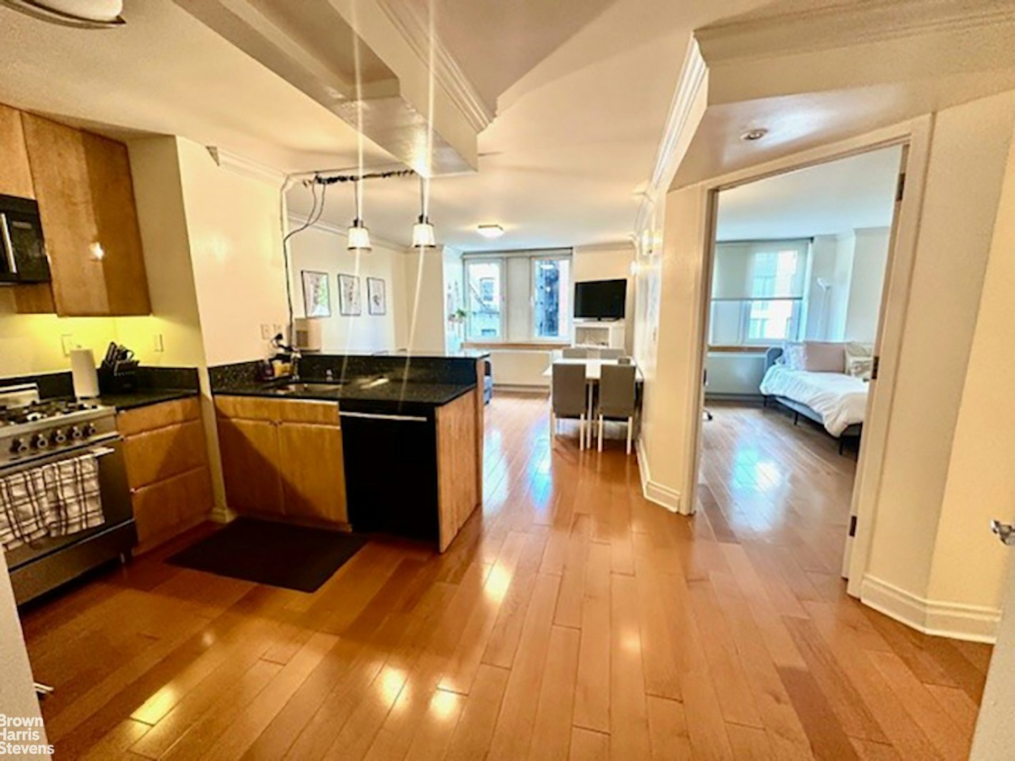 a kitchen with stainless steel appliances granite countertop a sink and wooden cabinets