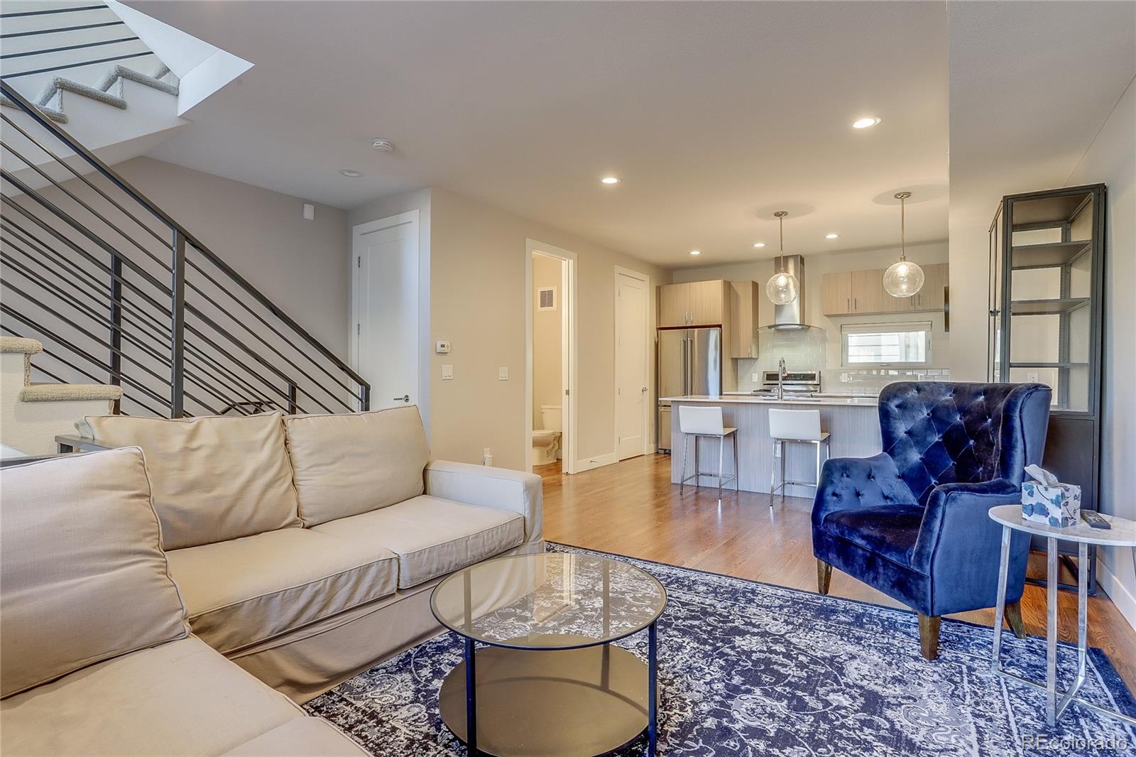 a living room with furniture and a dining table