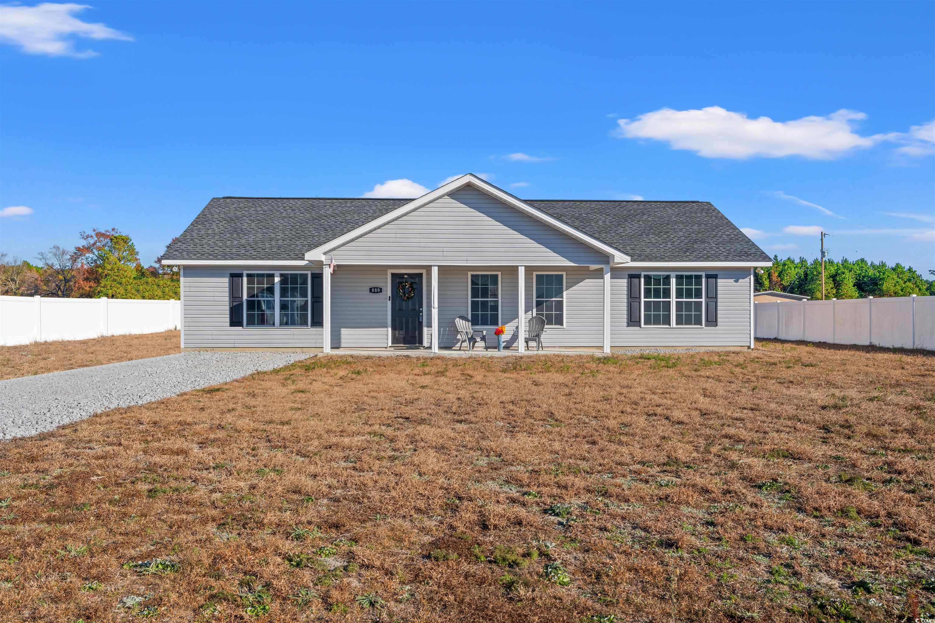 Ranch-style house with a porch and a front yard