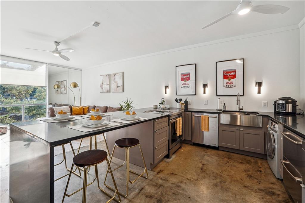 a kitchen with a sink stove and chairs