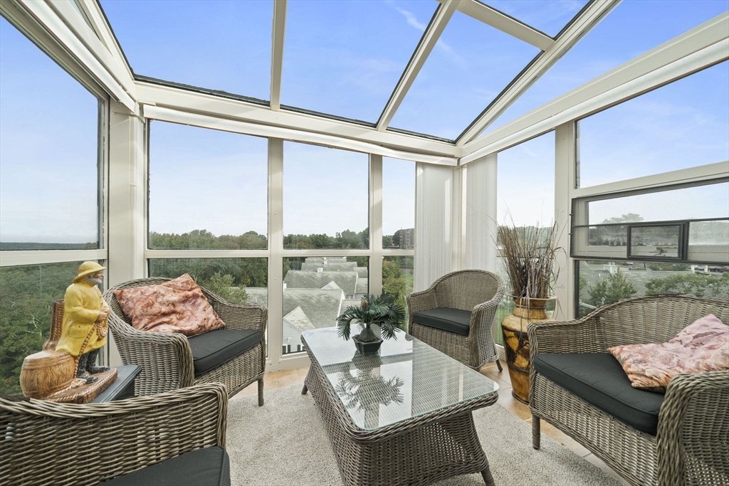 a living room with furniture and floor to ceiling windows