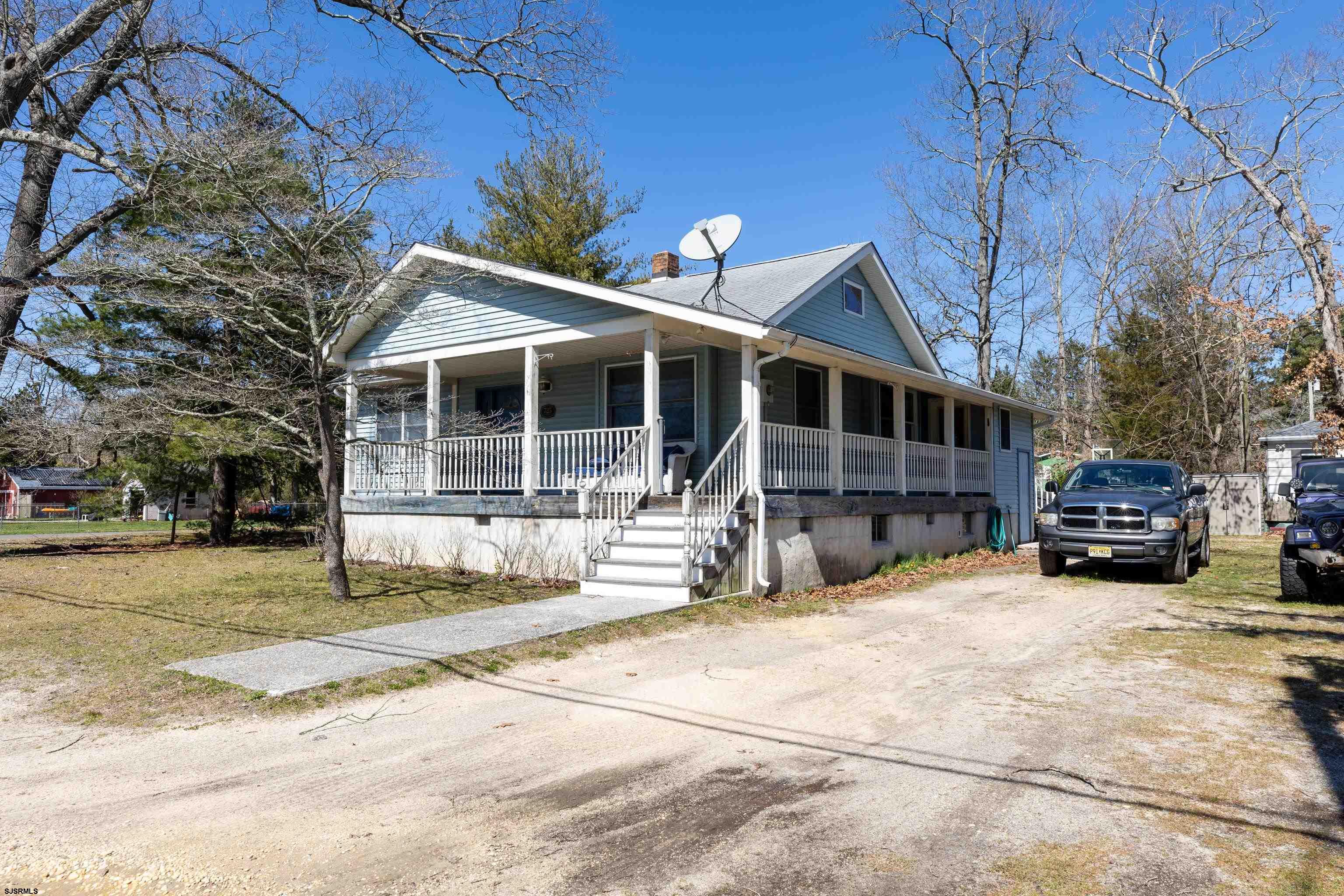 a front view of a house with cars parked