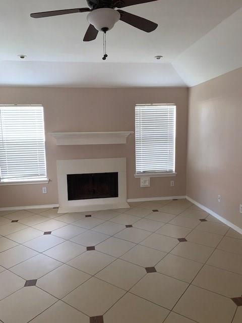 a view of empty room with cabinet and fireplace