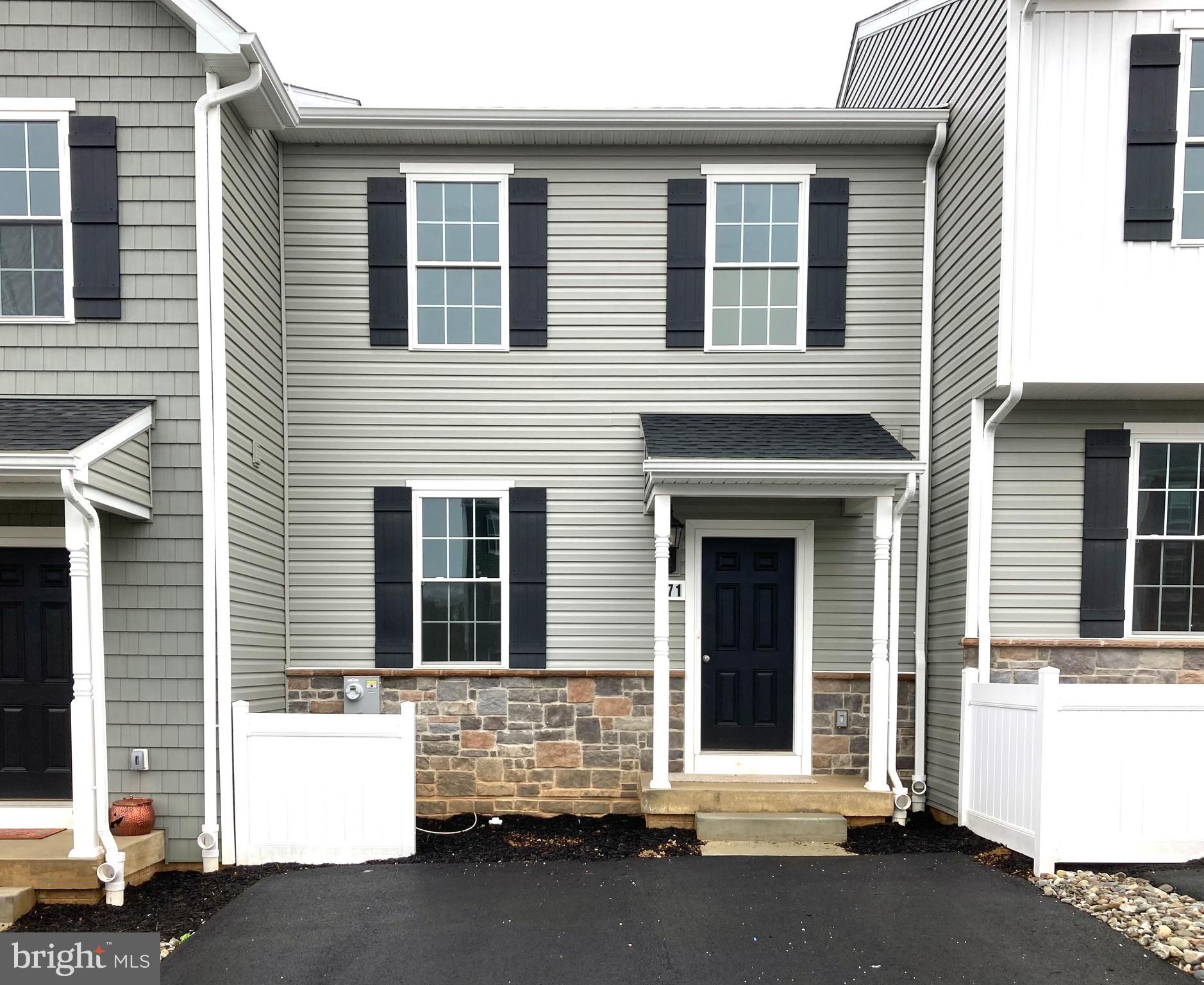 a front view of a house with a parking area