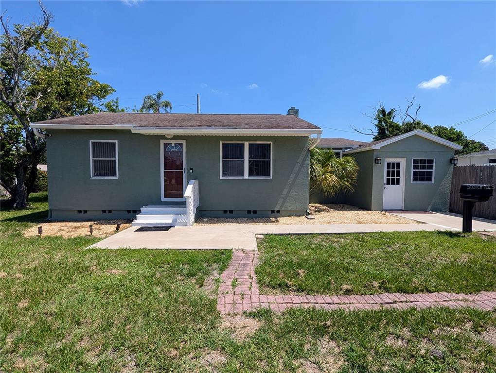 a front view of house with yard and green space