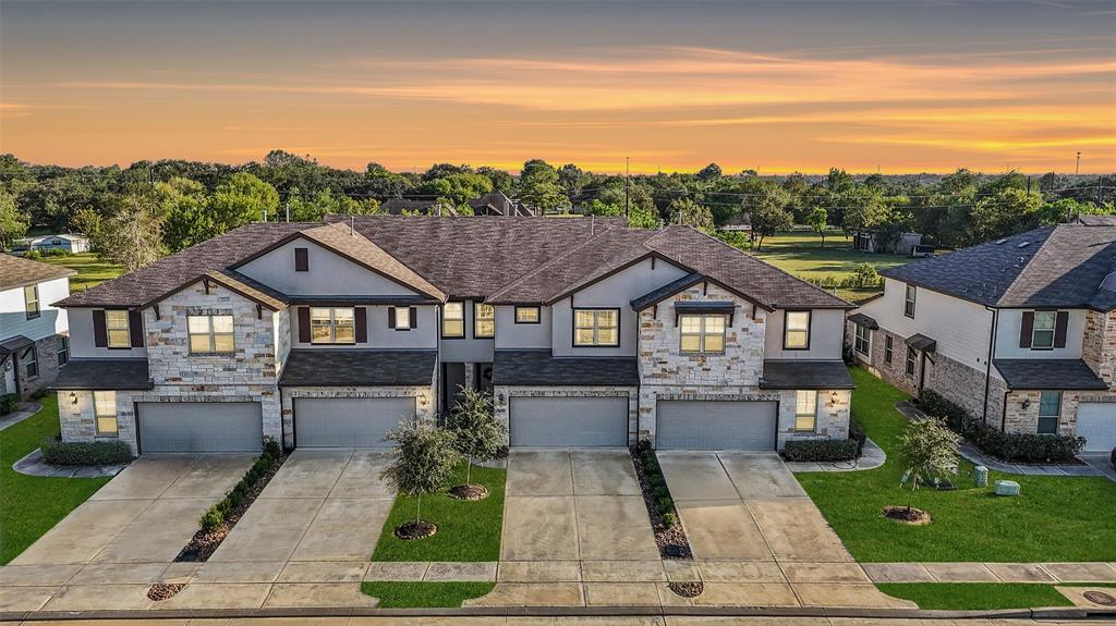 a view of a big house with wooden floor and a yard