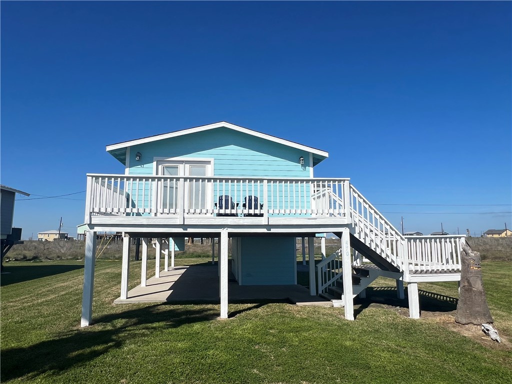 a view of a house with a deck yard and furniture