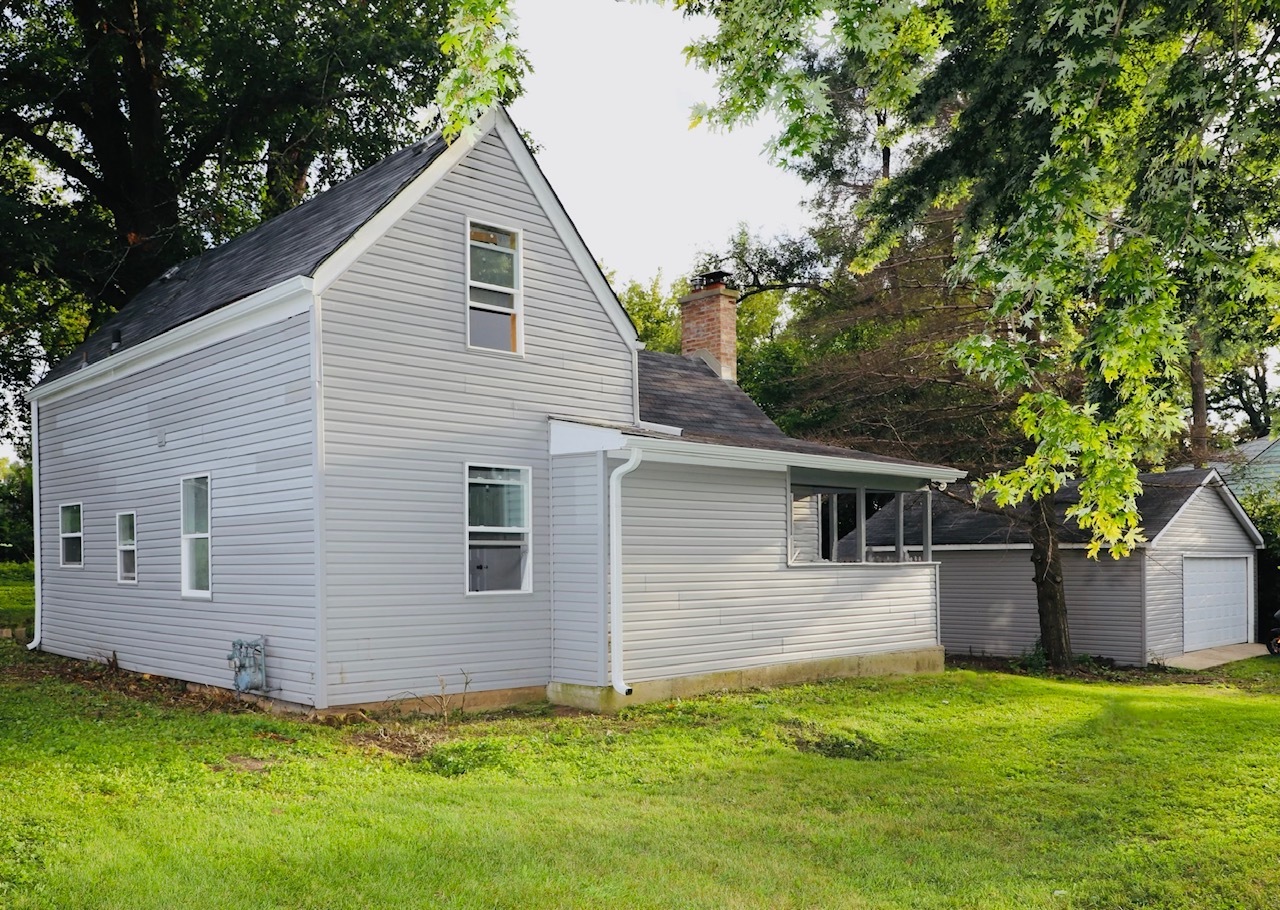 a front view of house with yard and trees