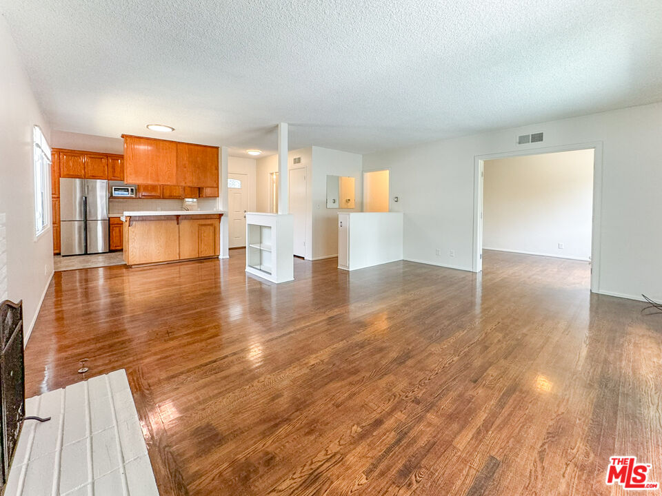 a view of a kitchen with wooden floor