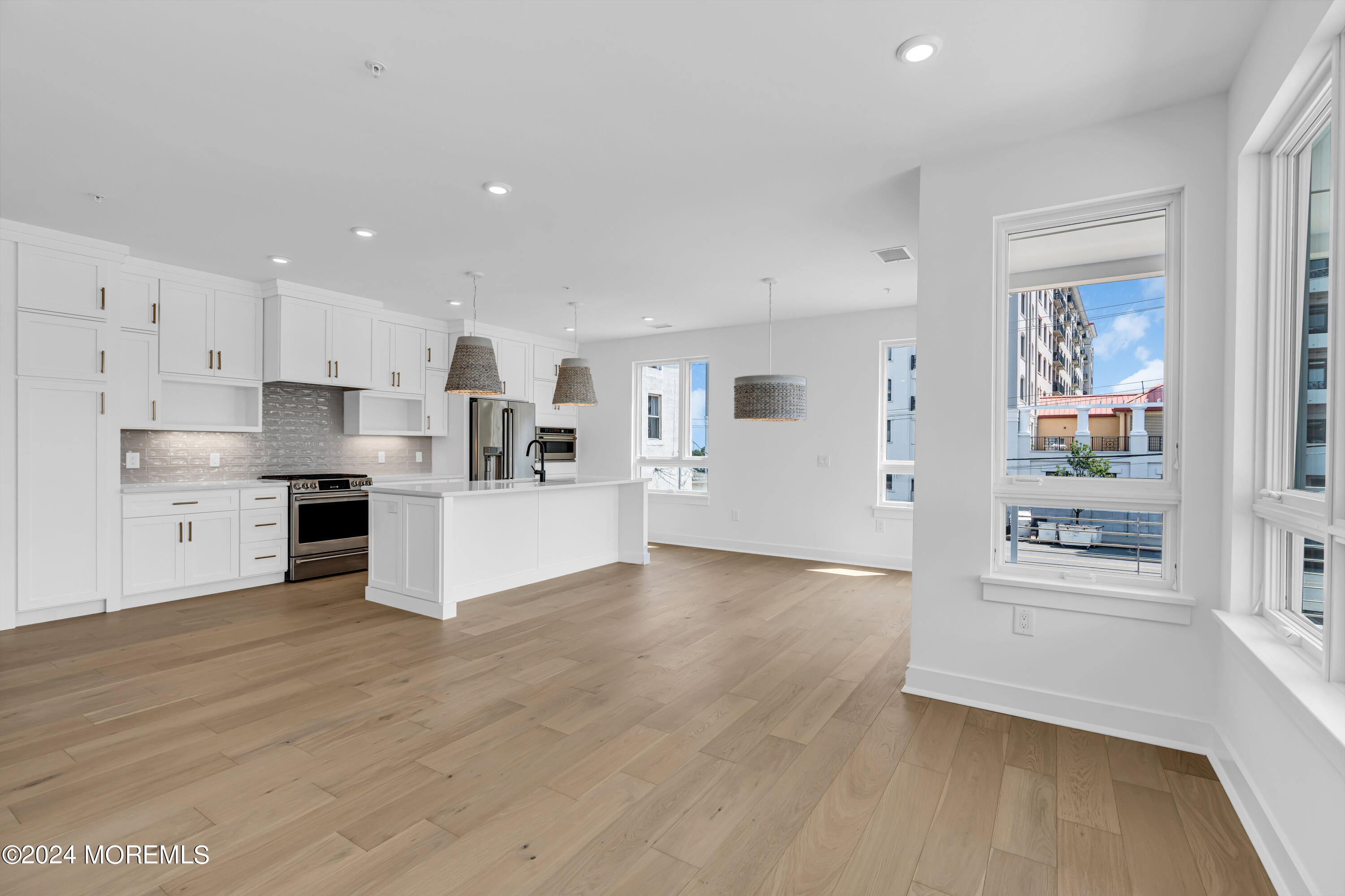 a view of kitchen with wooden floor and electronic appliances