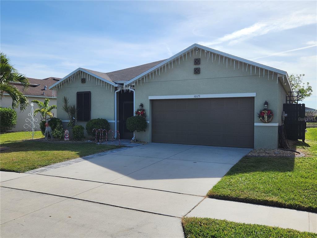 a front view of a house with a yard and garage