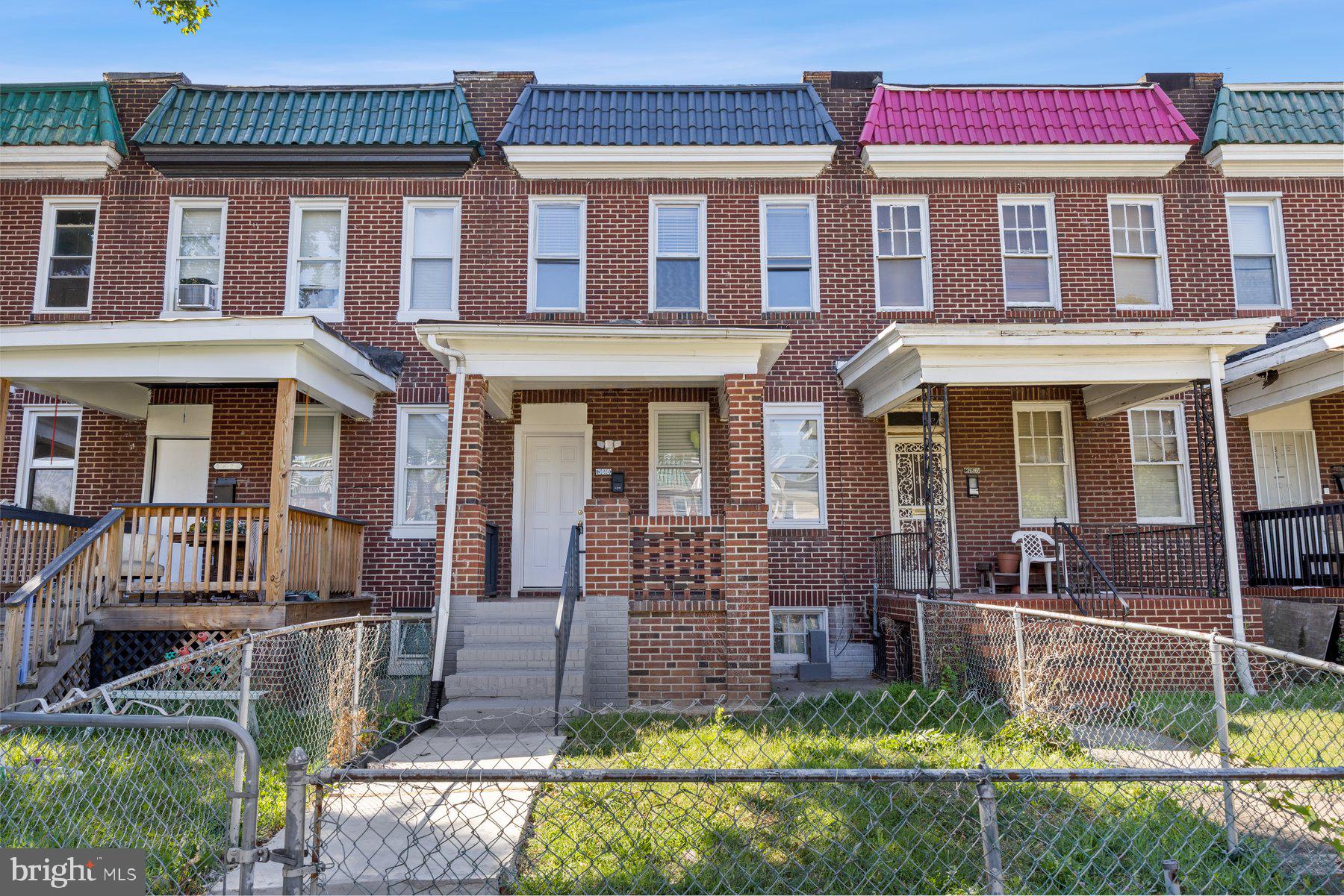 front view of a brick house with a yard