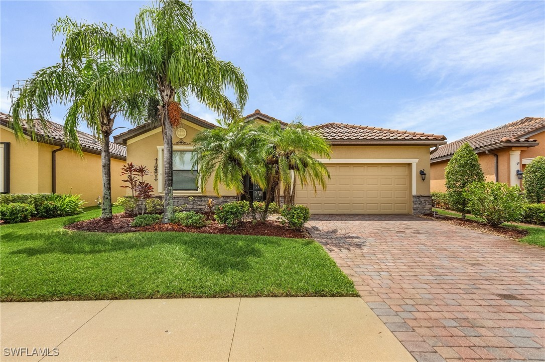 a view of a house with a yard and palm trees