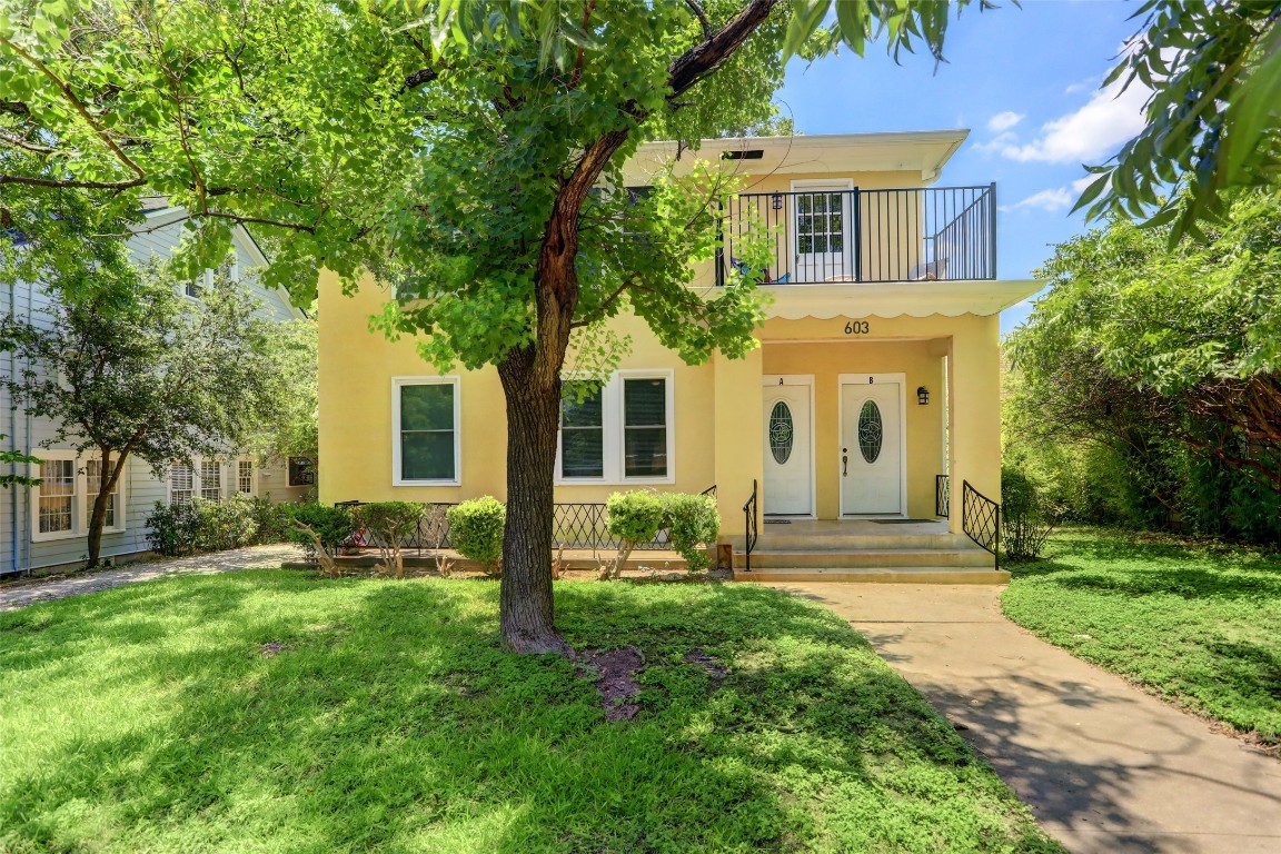 a front view of house with yard and green space