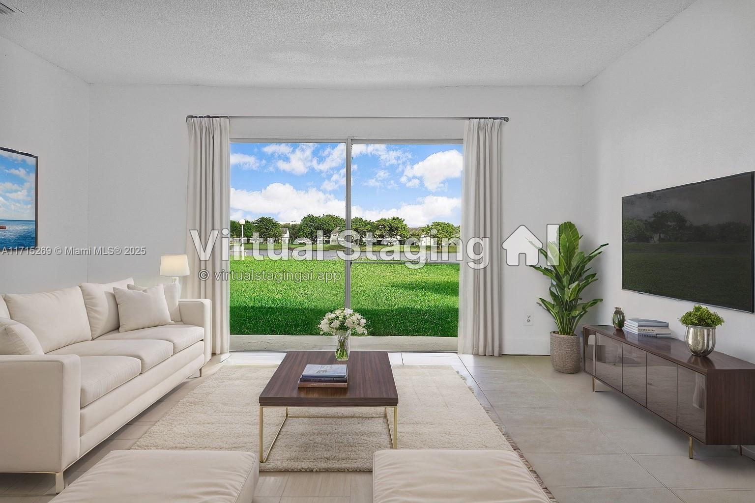 a living room with garden view and a flat screen tv