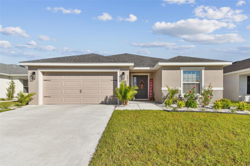 a front view of house with yard and outdoor seating